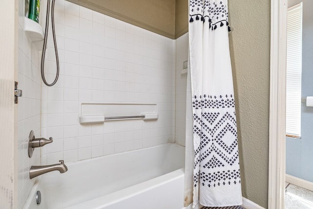 705 Fay St, Sonora, TX 76950 - bathroom featuring shower / bath combo and a textured wall