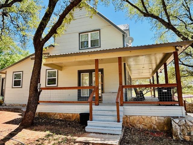 rear view of property featuring a porch