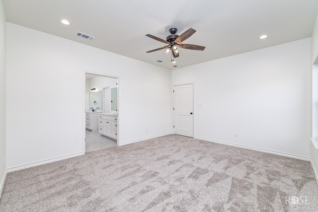 unfurnished bedroom featuring light colored carpet, visible vents, baseboards, and recessed lighting