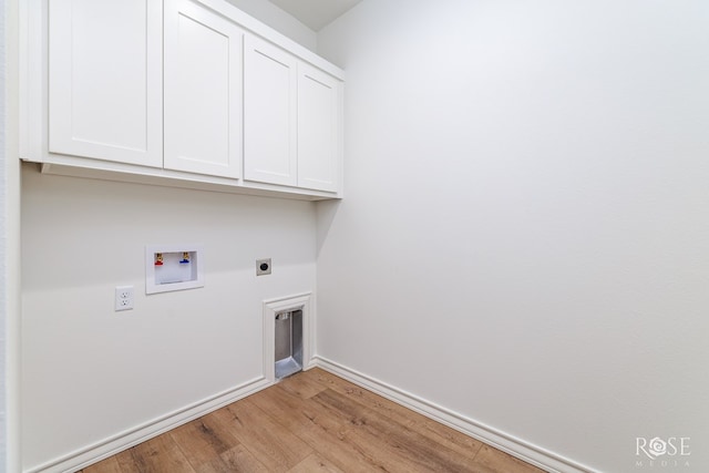 clothes washing area featuring washer hookup, baseboards, light wood-type flooring, cabinet space, and electric dryer hookup