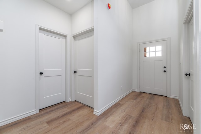 entryway featuring light wood finished floors and baseboards