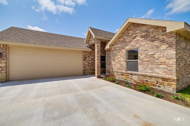 5441 Riviera Ln, San Angelo, TX 76904 - single story home with driveway, a shingled roof, an attached garage, and brick siding