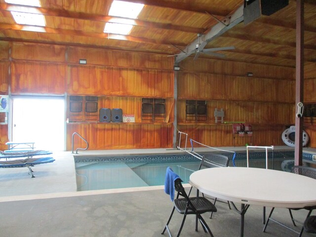 view of swimming pool featuring a hot tub