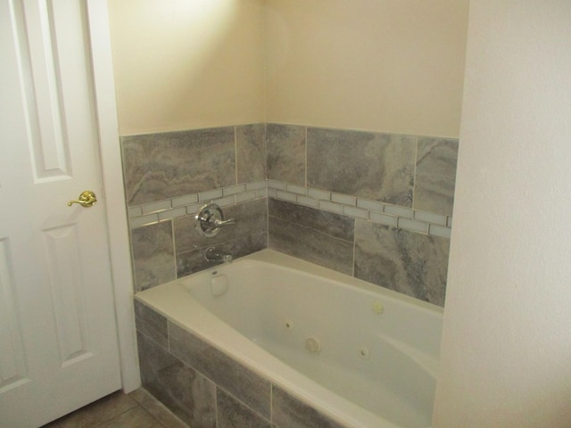 bathroom with tile patterned flooring and tiled tub