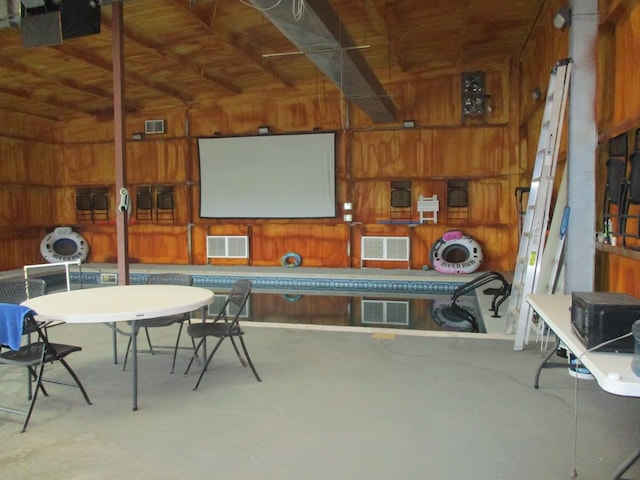 interior space featuring vaulted ceiling with beams, wood ceiling, and wood walls