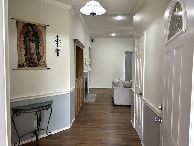 3570 Grandview Dr, San Angelo, TX 76904 - corridor with dark wood-style floors, ornamental molding, and a textured ceiling