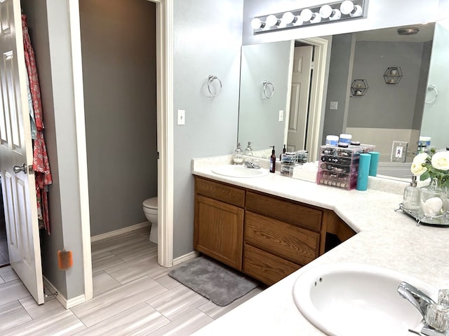 3570 Grandview Dr, San Angelo, TX 76904 - bathroom featuring double vanity and toilet