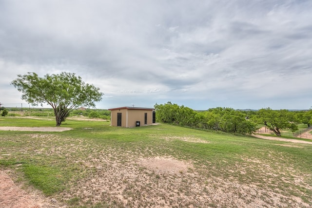 6290 Stokes Rd, San Angelo, TX 76904 - view of green lawn with an outbuilding and a pole building
