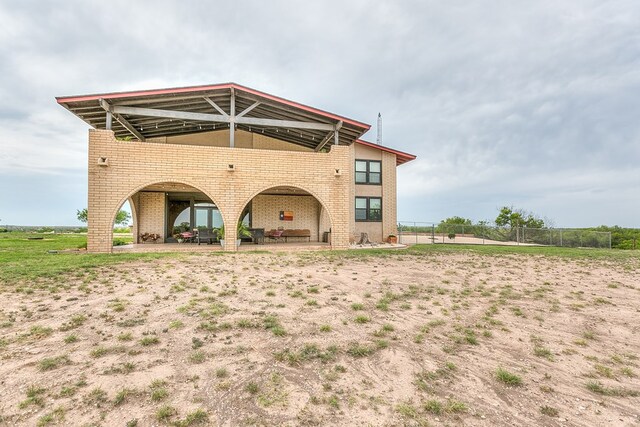 6290 Stokes Rd, San Angelo, TX 76904 - back of property featuring brick siding, a patio, and fence