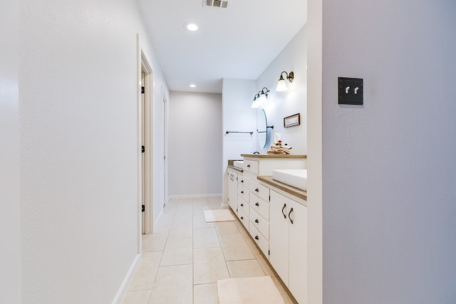 6290 Stokes Rd, San Angelo, TX 76904 - bathroom with double vanity, tile patterned flooring, baseboards, and recessed lighting