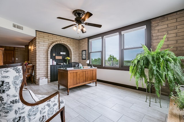 6290 Stokes Rd, San Angelo, TX 76904 - office area with brick wall, ceiling fan, and baseboards