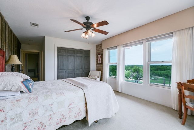 6290 Stokes Rd, San Angelo, TX 76904 - bedroom featuring light carpet, a closet, and a ceiling fan