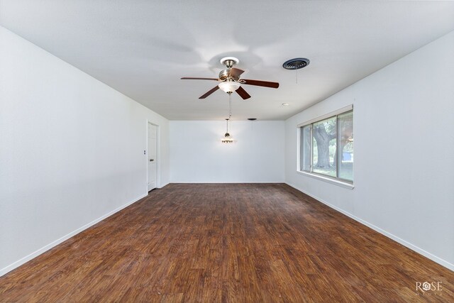 empty room featuring dark hardwood / wood-style floors and ceiling fan