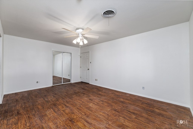 unfurnished bedroom with ceiling fan and dark hardwood / wood-style flooring