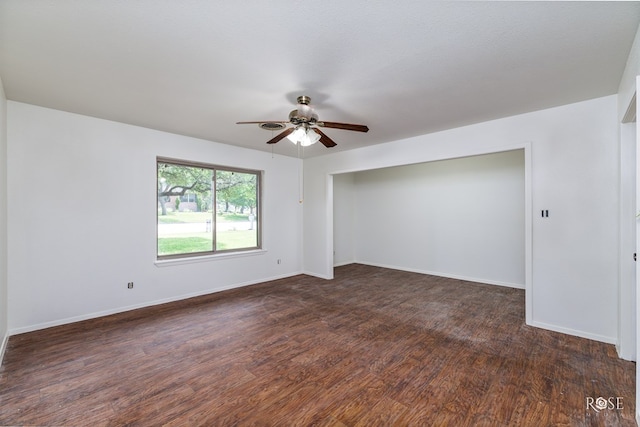 unfurnished room with ceiling fan and dark hardwood / wood-style flooring