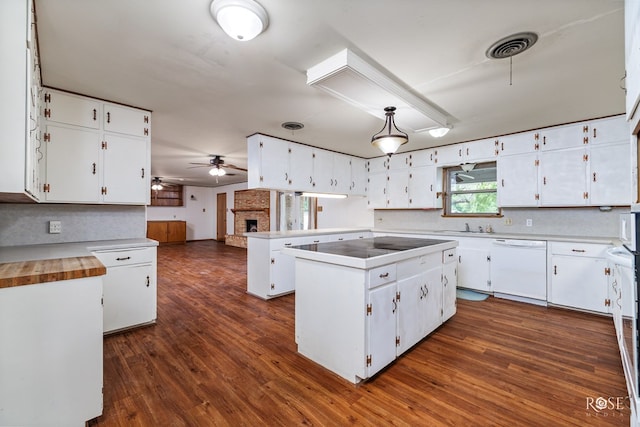 kitchen featuring dishwasher, a center island, dark wood-type flooring, and white cabinets