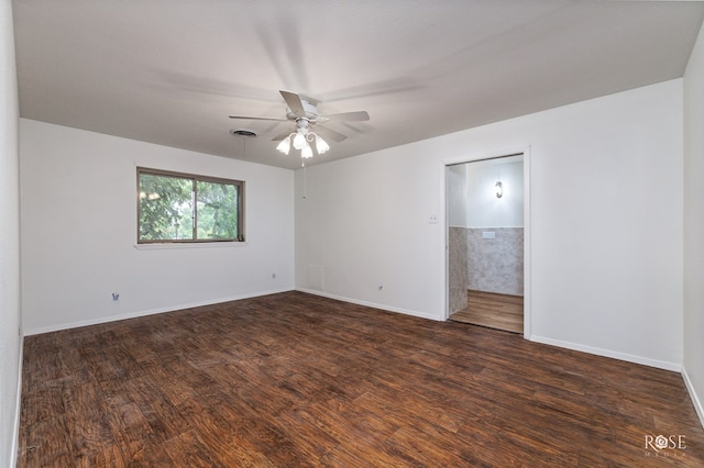 spare room featuring ceiling fan and dark hardwood / wood-style flooring