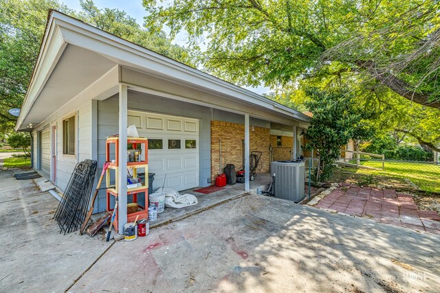 view of property exterior with a garage and central air condition unit