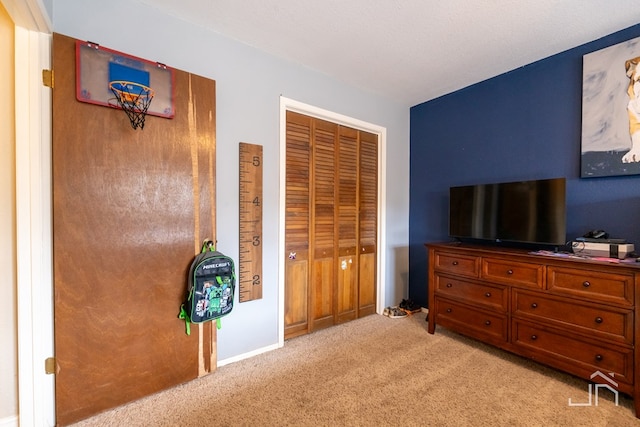 bedroom with light colored carpet and a closet