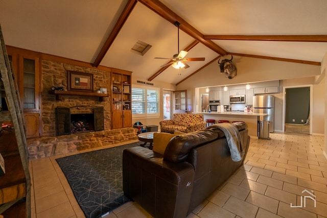 tiled living room featuring vaulted ceiling with beams, a stone fireplace, built in features, and ceiling fan