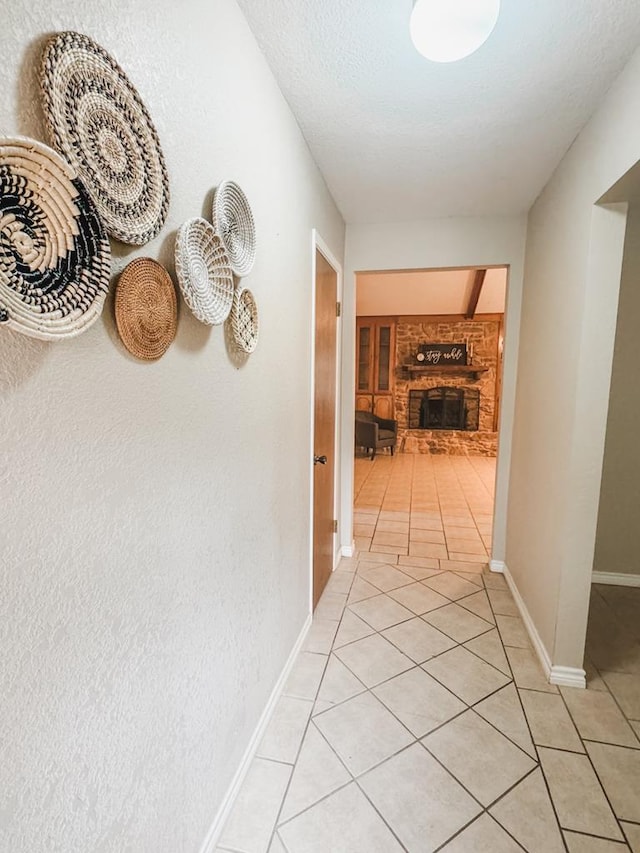 hall with light tile patterned floors