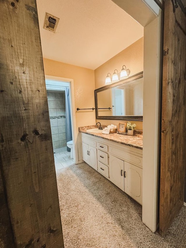 bathroom with vanity and toilet