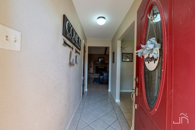 hall featuring light tile patterned floors