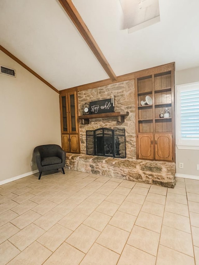 living room with vaulted ceiling with beams, light tile patterned floors, a fireplace, and built in shelves