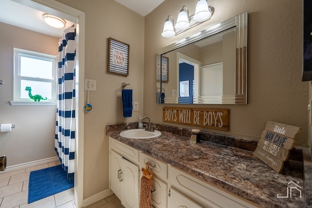 bathroom with tile patterned flooring and vanity