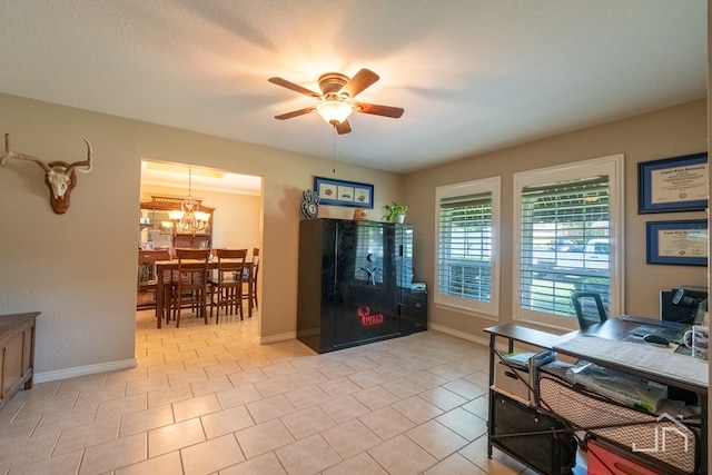 interior space with ceiling fan with notable chandelier