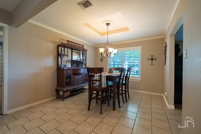 dining area with a tray ceiling, a notable chandelier, crown molding, and light tile patterned floors