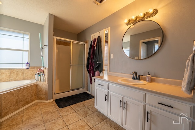 full bath with visible vents, a stall shower, tile patterned floors, a textured ceiling, and vanity