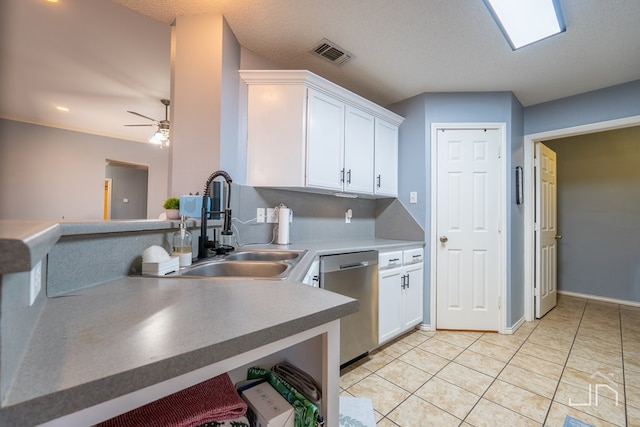 kitchen with stainless steel dishwasher, visible vents, white cabinetry, and a sink