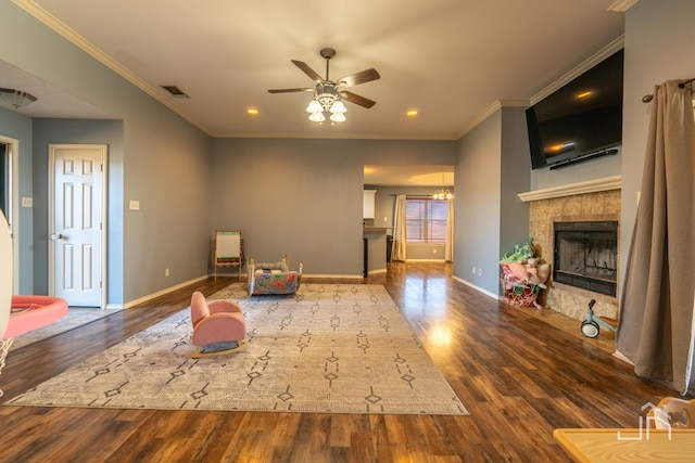 unfurnished room with visible vents, crown molding, baseboards, a fireplace, and wood finished floors