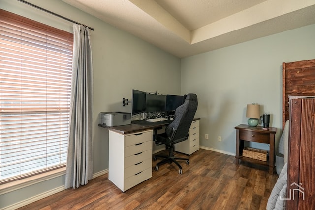 office area with a wealth of natural light, baseboards, and dark wood-style flooring