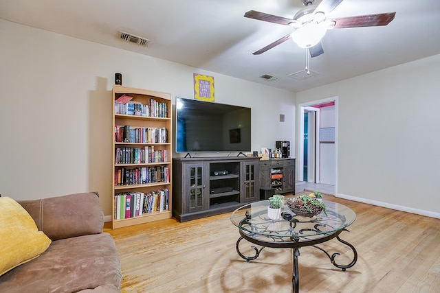 living room with ceiling fan and light hardwood / wood-style flooring