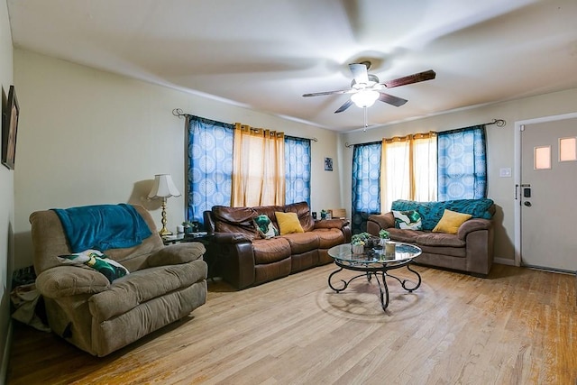 living room featuring ceiling fan and light hardwood / wood-style floors