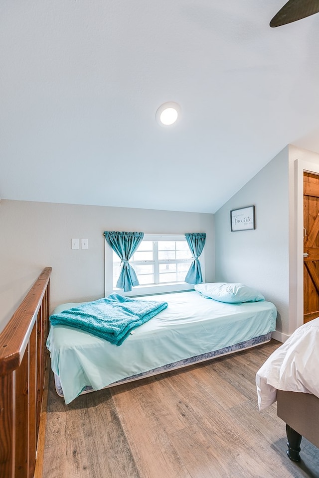 bedroom featuring wood-type flooring and lofted ceiling