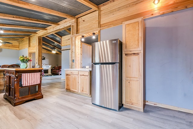 kitchen with ceiling fan, stainless steel fridge, and light brown cabinetry