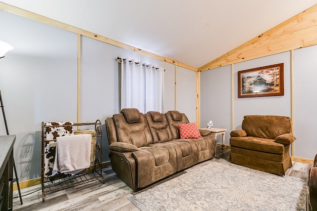 living room with hardwood / wood-style flooring and vaulted ceiling