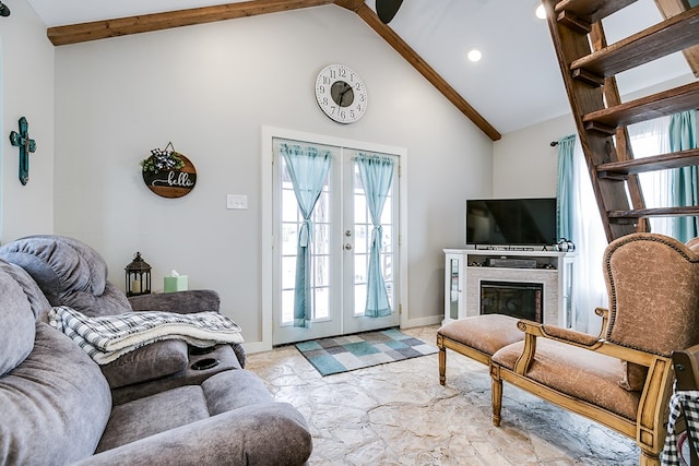 living room featuring high vaulted ceiling and french doors