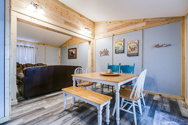 dining space with wood-type flooring and lofted ceiling