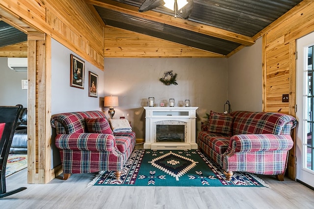 living area featuring vaulted ceiling with beams, hardwood / wood-style flooring, a fireplace, and a wall unit AC