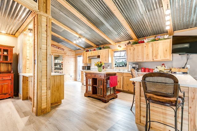 kitchen featuring a center island, light brown cabinets, and light wood-type flooring