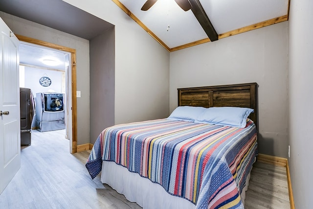 bedroom with beam ceiling, light hardwood / wood-style flooring, washing machine and dryer, and ceiling fan