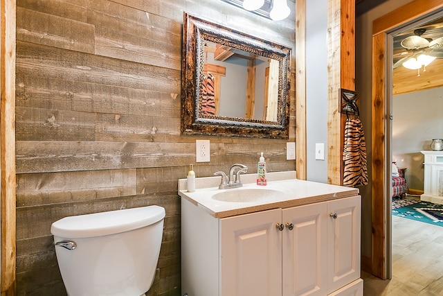 bathroom featuring hardwood / wood-style flooring, vanity, and toilet