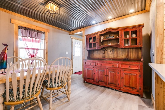 dining room with light hardwood / wood-style flooring and wooden ceiling