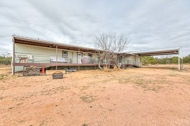 back of house featuring a fire pit