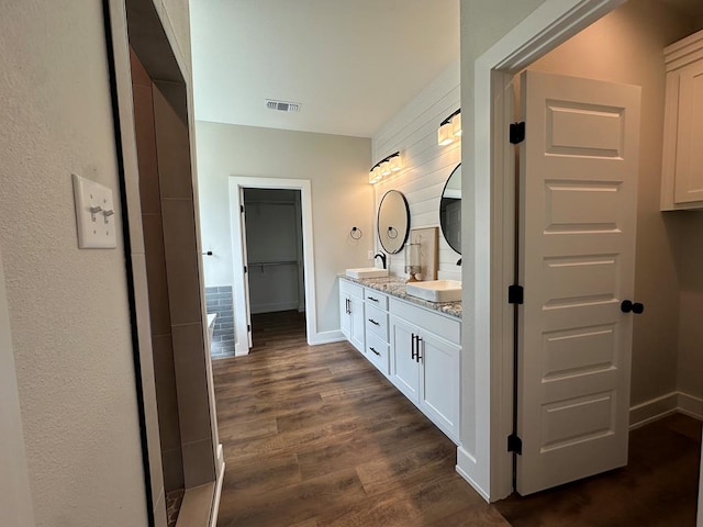 3611 Clearview Dr, San Angelo, TX 76904 - bathroom featuring double vanity and wood finished floors