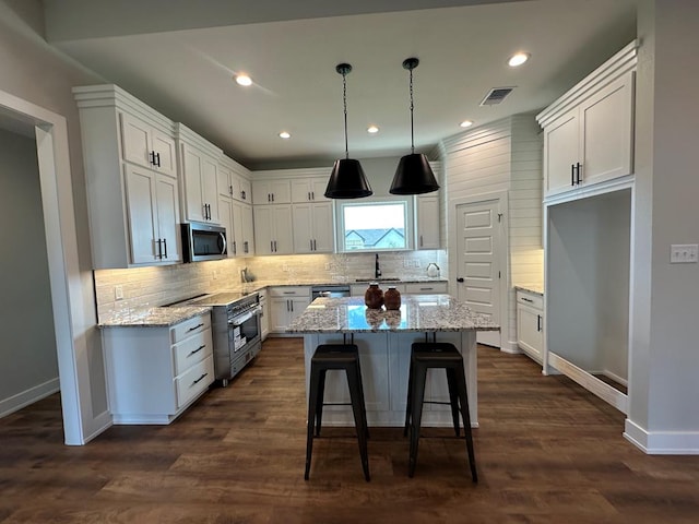 3611 Clearview Dr, San Angelo, TX 76904 - kitchen with appliances with stainless steel finishes, white cabinets, backsplash, and recessed lighting